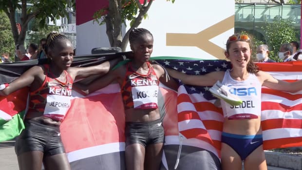 Peres Jepchirchir, Brigid Kosgei and Molly Seidel celebrate medaling in the women's Olympic marathon at the Tokyo Olympics.
